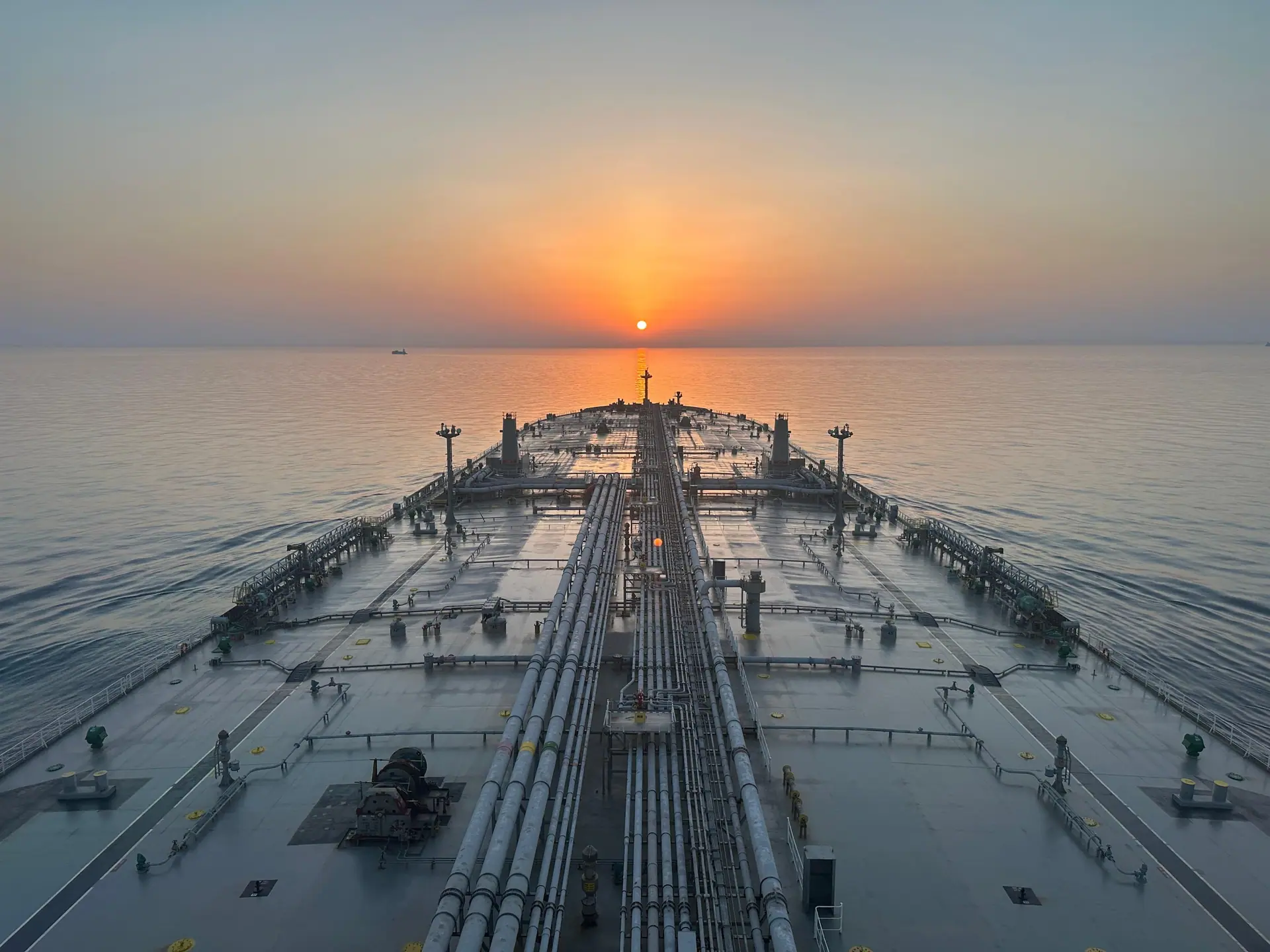 Vessel deck photographed at sunrise on open water.